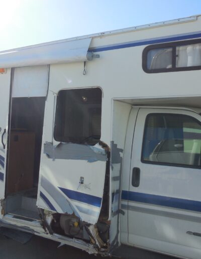 Heavy impact damage on the right side of a FleetWood RV
